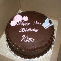 Birthday Cake This cake is yellow cake with strawberry jam filling and chocolate icing. The flowers are royal icing, and the butterfly is color flow.