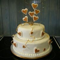 Hearts Chocolate sponge bottom tier and fruit cake for the top tier. Rolled fondant used to cover the cakes and for the hearts. This cake was made...