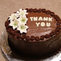 Dscf4899.jpg This is a thank you cake I made for my field experience teacher. It is a chocolate cake with chocolate frosting. The flowers a royal icing...