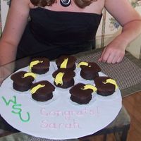 Graduation Cupcakes These are brownie cupcakes turned upside-down and topped with a square chocolate covered graham cracker. The tassles are made of fondant.