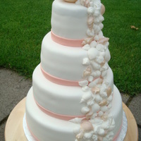 Shells On The Weddingcake Wedding cake with an oister on top, and rings insite.