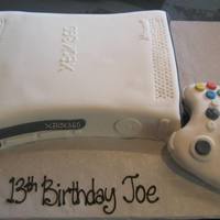 Xbox 360 xbox 360 and controller.Controller made with RKT covered with fondant and details. 9x13" sheet cake cut to shape and covered with...