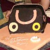 Purse.jpg i made this cake for a friends mom, it was an amaretto cake with amaretto mocha buttercream filling i really wasnt happy with the turnout...
