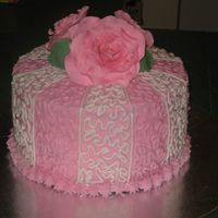 Roses And Cornelli Lace this is an 8" tripple torted cake with buttercream frosting and gumpaste roses in graduated sizes from 20 petals to 10petals.