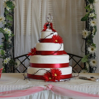Western Wedding 6, 10,12, 16 inch rounds, white with raspberry filling and buttercream icing. Ribbon around bottom of each tier is satin. The bride...