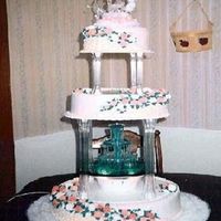 3 Tier Basket Weave This 3 tier was the basket weave on half of the rounds. Then roses and buds going up the sides with the fountain. It was a big sucess!...