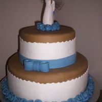 Angel Birthday Cake White chocolate cake with IMBC and strawberry mousse filling. Covered with MMF. Collectible angel on top.