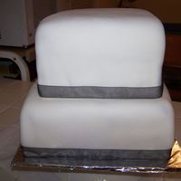 Plain White Fondant Square Cake The lady wanted white with black ribbon and wanted it to look like a box. After I delivered it to her she took it and (I believe put a...