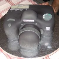Camera Here's the front side of the Camera cake I made for my Photographer hubby's Birthday! Gotta love that black fondant! :)