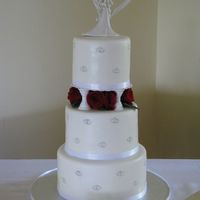 Silver Hearts Fondant covered cakes, satin ribbon and real roses.