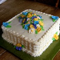 Dscf2301.jpg Lemon cake with raspberry filling, iced in crusting cream cheese icing. Royal icing flowers.