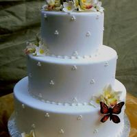 Grace Fondont with a Swiss dot. The Sugar flowers are Jockham Orchids that I bought. The butterflies were bought as well but hand painted to look...