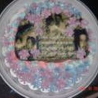 Fathers Day made collage of pictures in photoshop, then had printed on icing sheet. Just did a swirl of flowers as cake fell apart