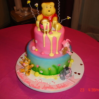Baby Pooh And Friends White sour cream cake with white chocolate ganache fill , butter cream and fondant. Fondant and gum paste used for deco and characters.