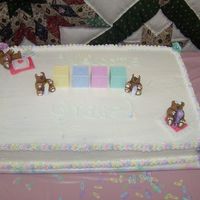 100_0261.jpg 12x18 sheet cake. half white cake and half devils food cake. The bears were done out of fondant. First time working with fondant and loved...
