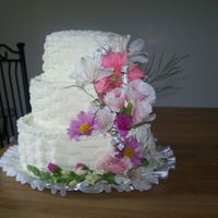 100_1133.jpg 3 tier white cake iced in BC. Basket weave design with real flowers for a small wedding that was this evening.