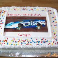 100_0319.jpg I done this cake for one of the guys that work for my husband. He races stock cars so I done an edible image of his race car and put on the...