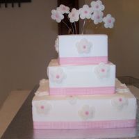 100_1123.jpg This is a three tier dummie cake. Flowers are made out of fondant.