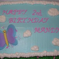 Butterfly And Clouds 9" x 13" cake with fondant butterflies brushed with pearl dust. The second butterfly was on a stick to be placed by Mandy's...