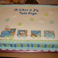 Baby Train MMF fondant buttons and stars. Buttercream frosting and strips on side of cake.
