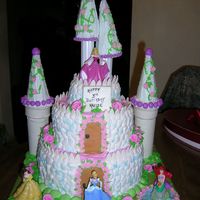 A Princess Castle Iced in butter cream, with fondant accents and plastic princess.