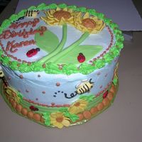 Sunflower Birthday 8" white layer cake with lemon filling. Iced with buttercream, with MMF decorations.