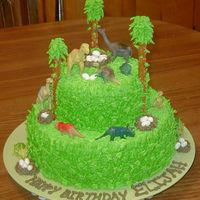 Dinosaur Cake Made for a 7 year old who loved dinosaurs. White Almond Cake with bc frosting, jelly bellys for dino eggs and pretzel rods to help with...