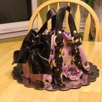 Juicy Couture Knock-Off Purse Cake I did this cake a couple of weeks ago for my daughters friends birthday. Then I sent it on an 800 mile road trip in a well packed box, and...