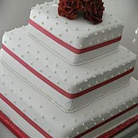 Red Theme Wedding Cake vanilla and chocolate cake. marshmallowcreme buttercreme frosting. strawberry filling. white rolled fondant. gumpaste roses and pearls.