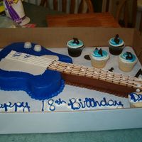 Guitar First guitar cake & it didn't turn out like I wanted! Carved from a 12x18,frosted in buttercream with MMF accents. Cupcakes have...