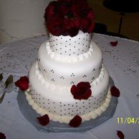 Wedding Cake My first wedding cake and first time working with rolled fondant. White cake with french vanilla custard filling. The dots are a pewter...