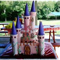 Pink Castle Cake THIS IS A SQUARE 10 CAKE WITH A 6" ON TOP.THE COLUMS ARE ROYAL ICING DIPPED ICECREAM CONESW/CAKE SPARKLES. THE DOORS AND WINDOWS ARE...