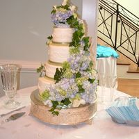 Cascading Roses And Hydrangeas This cake was made for a wedding on Saturday, March 8th, 2008. The cake was french vanilla with blueberry filling and vanilla buttercream...