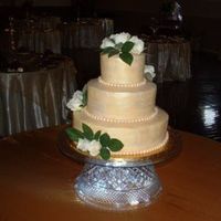 Golden Wedding Cake French vanilla cake with lemon cream cheese buttercream icing. Fondant pearls and whole cake dusted with gold pearl dust.