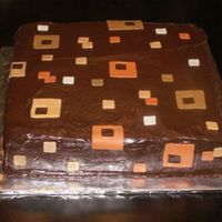 Squares Chocolate cake filled and iced with chocolate ganache. The squares were cut out of fondant.