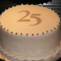 Silver Anniversary This chocolate cake with brandied raspberry jam and chocolate ganache fillings was wrapped in MMF and decorated with silver dragees and an...