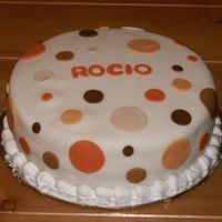 Polka Dots Simple, fondant covered cake featuring polka dot cutouts.
