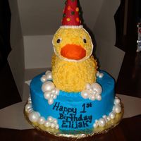 Party Duck Ducky cake with party hat (iced ice cream cone). Bubbles are fondant dusted with super pearl dust.