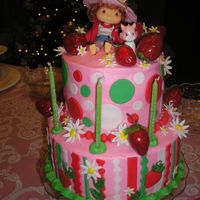 Ali's Strawberry Shortcake for my daughter's third birthday. b/c with fondant decorations, except for doll, cat and life like strawberries.