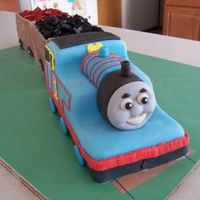Thomas The Tank Engine For my son's 3rd birthday. Started with a 12x18 sheet cake & made Thomas & the 2 cars behind him. Covered in MMF with piped...