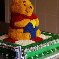 1St Birthday Cake Side My first cake, made for my son's 1st birthday. I decided to do Pooh on a picnic blanket on grass with some royal icing flowers, side...