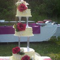 Wedding Cake This wedding cake it is made with three milk cake, butter cream and some fondant with silk flowers.