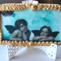 Edible Image Angel Artwork Sugar cookie with royal icing and edible image placed on top. Royal icing "frame" around picture. Gold luster dust added to frame...