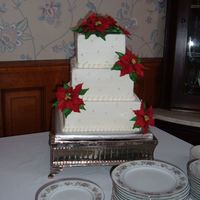 Poinsettia Wedding Cake 10", 8" & 6" square BC wedding cake. I made the poinsettias from gumpaste. I got the cutters from Scott Woolley. He was...
