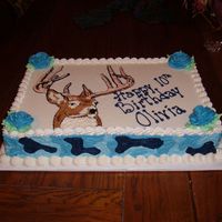 Deer Hunter This was for a 10 yr. old girl who is a deer hunter. She likes the blue camo, so I put it on the sides of the cake. Added the blue roses...
