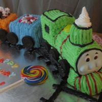 Percy Train Cake Chocolate & Vanilla cake with bc icing. Face of train is fondant/gumpaste and train tracks are black licorice. TFL. :-)