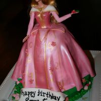 A Sleeping Beauty Fondant covered cake with gold luster accents.
