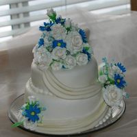 White Roses With Blue Daisies This is my very first paid wedding cake.