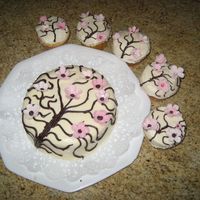 L_041.jpg Red velvet, cherry blossom, cake and cupcakes. The little flowers are gumpaste, It's suppose to look like a cherry blossom tree with...