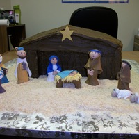 Christmas Nativity This cake was made for a Christmas celebration. The manger is a four tier cake with buttercream frosting. The figurines are all made of...